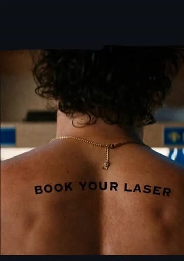 Aura Aesthetics client with the words book your laser written across her back